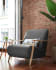 Meghan armchair in black with solid ash wood legs in a natural finish