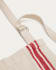 Nona apron in a natural linen and cotton with red stripes